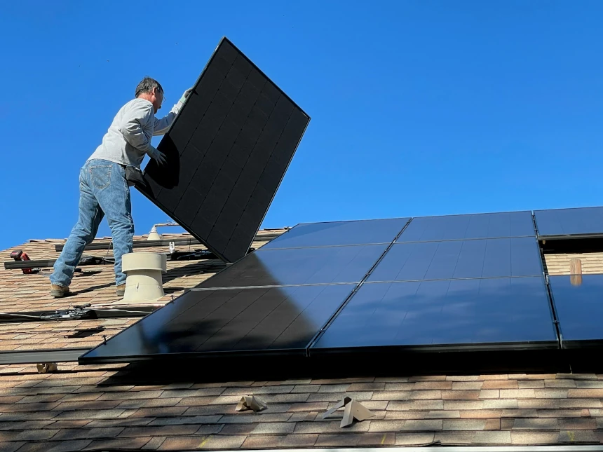 Solar panels being installed on a tile roof by